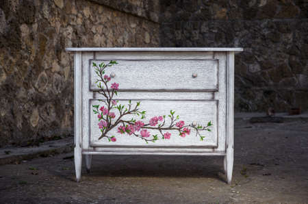 Chest of drawers made of solid natural wood with hand-painted artの写真素材