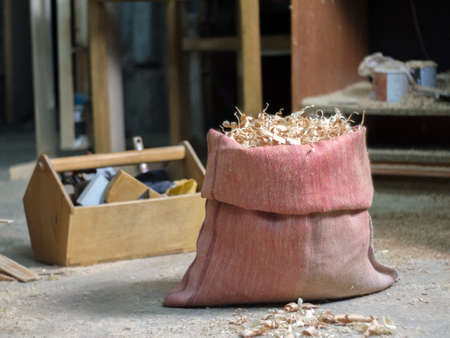 Red bag made of real dense burlap with natural wood sawdustの写真素材
