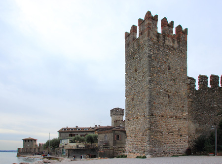 fragment of the fortress wall with a corner tower and promenade in front of the Scaliger Castleのeditorial素材