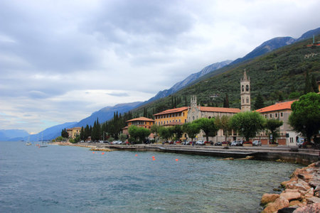 Promenade of town Castelletto with a chapel, cathedral and mountains in the backの写真素材