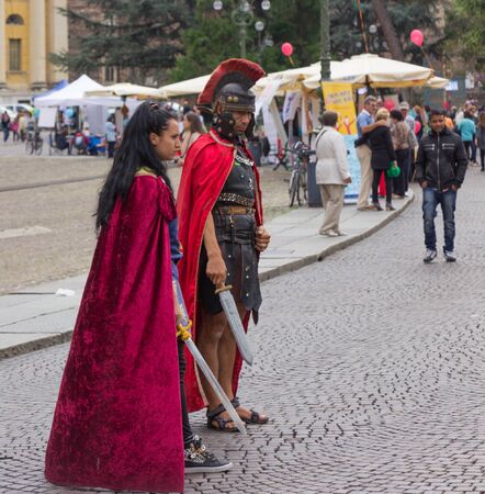 Verona, Italy, September 27, 2015: Man and woman dressed as legionnaires expect wishing to be photographed with them in Piazza Bra, in Verona, Italyのeditorial素材