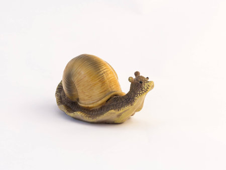 Clay figurines of a crawling snail on a white backgroundの写真素材