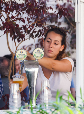Tel Aviv, Israel, September 16, 2016: The seller of the annual beer festival pours beer into a glass in Tel Aviv, Israelのeditorial素材