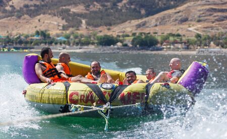 Tiberias, Israel, September 27, 2016: Group of young men floating on an inflatable attraction on Lake Kinneret in Tiberias, Israelのeditorial素材