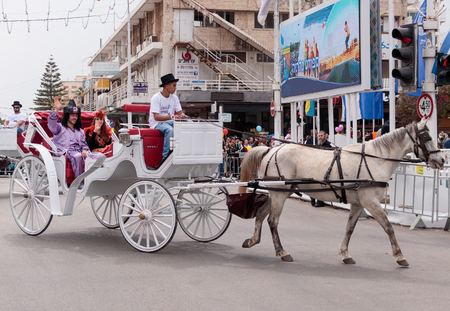 Nahariyya, Israel, March 10, 2017: Dressed in costumes participants of traditional annual Ñarnival parade "Adloyada" ride in an open carriage along the street and waved their hands to the viewers in Nahariyya, Israelのeditorial素材