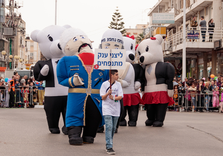 Nahariyya, Israel, March 10, 2017: Participants at the traditional annual Ñarnival parade "Adloyada" dressed in large inflatable suits are walking along the street in Nahariyya, Israelのeditorial素材