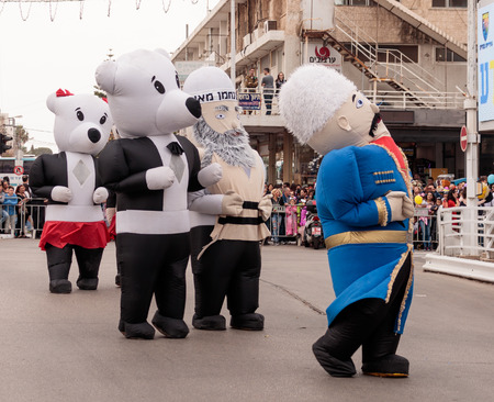 Nahariyya, Israel, March 10, 2017: Participants at the traditional annual Ñarnival parade "Adloyada" dressed in large inflatable suits are walking along the street in Nahariyya, Israelのeditorial素材