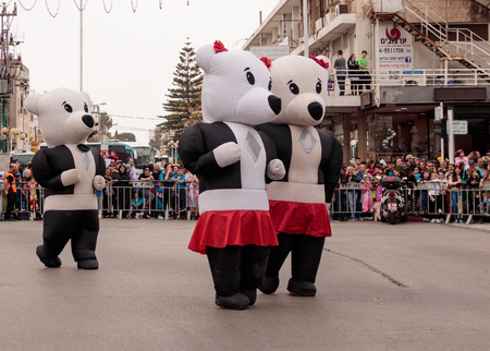 Nahariyya, Israel, March 10, 2017: Participants at the traditional annual Ñarnival parade "Adloyada" dressed in large inflatable suits are walking along the street in Nahariyya, Israelのeditorial素材