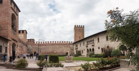 Verona, Italy - September 26, 2015 : Tourists walking in the courtyard of the Castelvecchio Museum on a cloudy day, inspect the museum and take pictures in Verona, Italy.のeditorial素材
