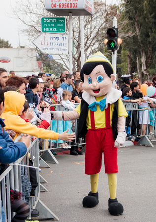 Nahariyya, Israel, March 10, 2017 : Participant in the traditional annual carnival parade "Adloyada" dressed in the suit of Pinocchio goes near the viewers and gives them a hand in Nahariyya, Israelのeditorial素材