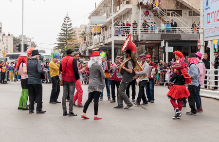 Nahariyya, Israel, March 10, 2017 : Participantin in the traditional annual carnival parade "Adloyada" walking near the viewers and playing musical instruments in Nahariyya, Israelのeditorial素材