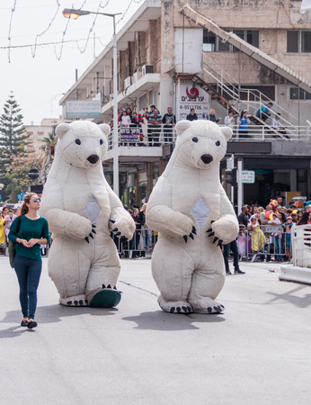 Nahariyya, Israel, March 10, 2017 : Participants in the traditional annual carnival parade "Adloyada" dressed in the big suit of white bears going near the viewers in Nahariyya, Israelのeditorial素材