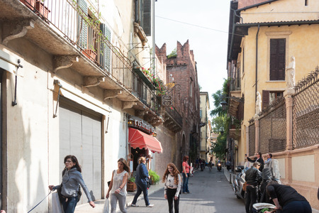 Verona, Italy - September 26, 2015 : Tourists walk the streets of Verona, inspect the sights and photograph them in Verona, Italyのeditorial素材