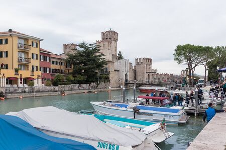 Sirmione, Italy - October 01, 2015 : View of the Castello Scaligero fortress, on Lake Garda, from the pier of Sirmione, Italyのeditorial素材