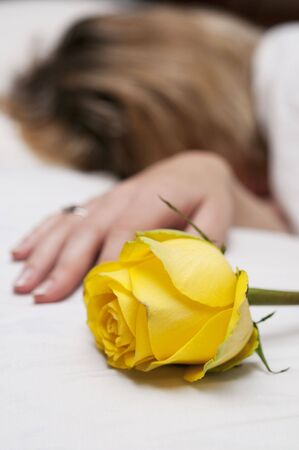 Yellow rose and love letter near sleeping girlの写真素材
