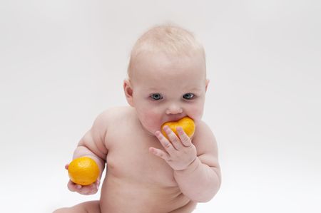 Little baby girl with tengerine