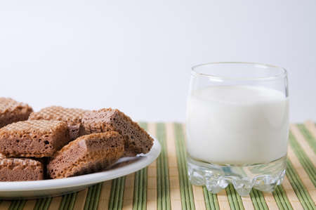 Glass of milk and chocolate wafflesの写真素材
