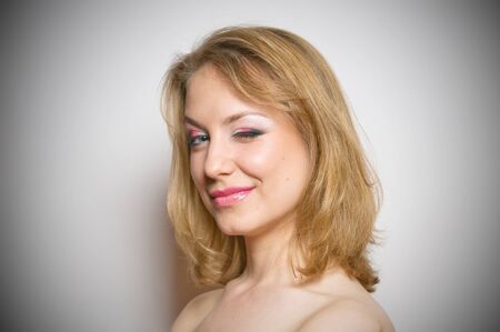 Portrait of a young beautifull blond girl with make-up in studio 