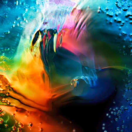 Abstract colorful rainbow liquid background. Swirls of color around the center focusing attention. Rendered design elementの写真素材