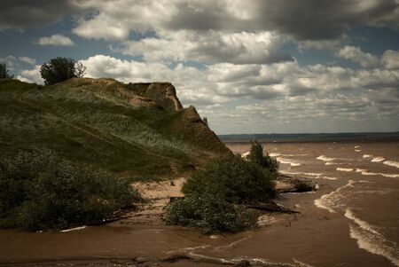 wind and waves with the clouds floating on the skyの写真素材