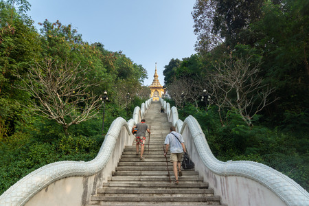People climb up the high steps. Rise to the temple.の写真素材