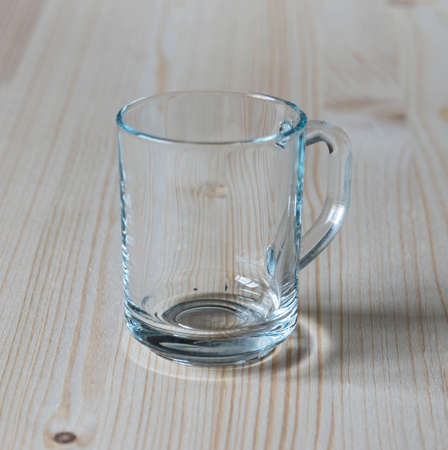 Glass mug on a wooden tableの写真素材