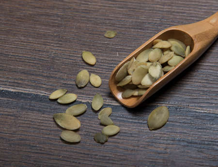 Wooden spoon with pumpkin seedsの写真素材