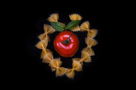 Heart made from pasta with tomato and basilの写真素材