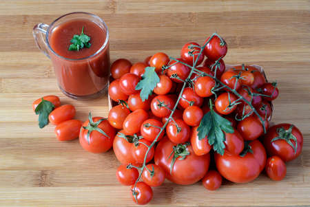 Tomato juice in glass and fresh tomatoesの写真素材