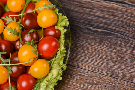 Cherry tomatoes with arugula  and  in a glass plateの写真素材
