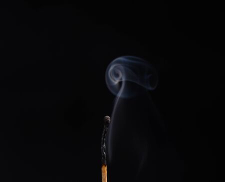 Smoky curls. Black backgroundの写真素材