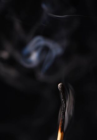 Smoke from an extinct wooden match close upの写真素材