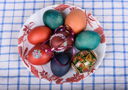 Easter colored eggs on a plateの写真素材