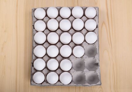 White chicken eggs in a cardboard package with empty spaceの写真素材