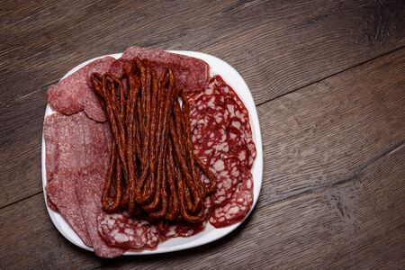 Different sausages of slicing on a white plateの写真素材