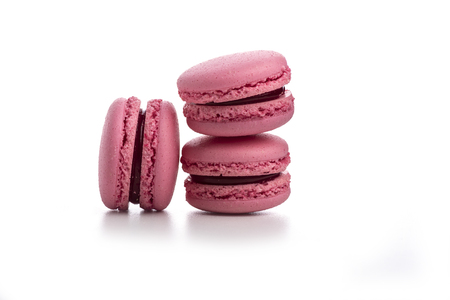 Three pink macaroons isolated on white backgroundの写真素材