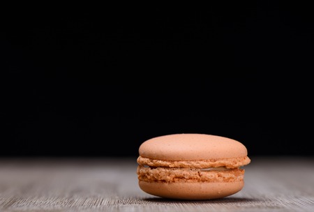 Orange macaroon on wooden background, rustic styleの写真素材