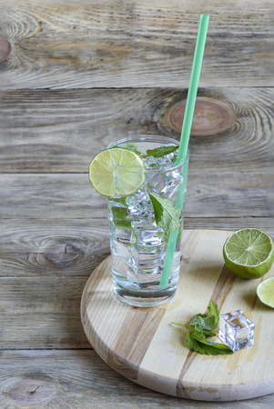 A refreshing cocktail with melissa leaves and a slice of limeの写真素材