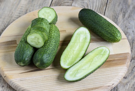 Fresh cucumbers, halves of cucumbers and slices of cucumberの写真素材
