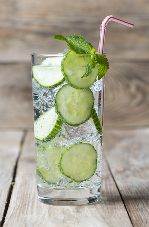 Cold fresh lemonade with cucumber, ice, mint and cocktail tubeの写真素材