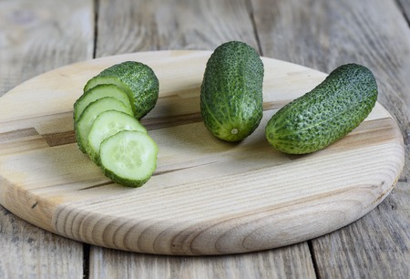 Fresh cucumbers on a cutting boardの写真素材