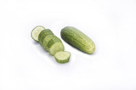 Fresh cucumbers, whole cucumber and slicedの写真素材