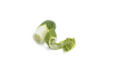 Fresh cucumber and curls of peel isolated on white backgroundの写真素材