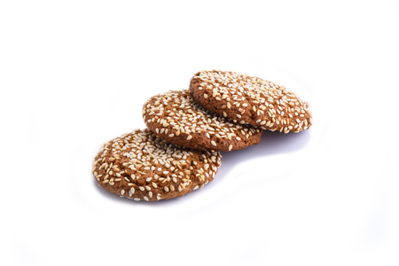 Three oatmeal cookies with sesame seeds isolated on white backgrの写真素材