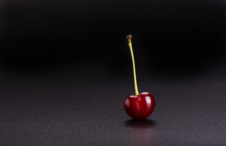 Ripe cherry isolated on black backgroundの写真素材