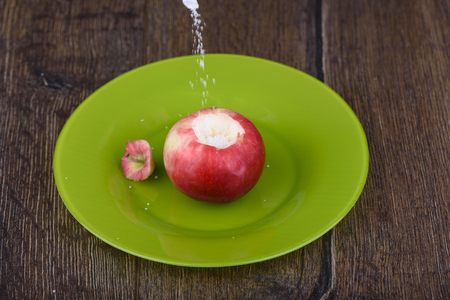 Rustic style. Filling the apple cut with sugarの写真素材