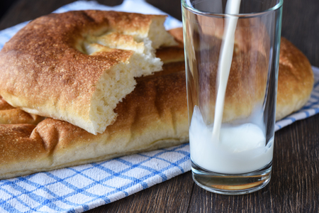 Rustic style. Milk is poured into a glass close upの写真素材