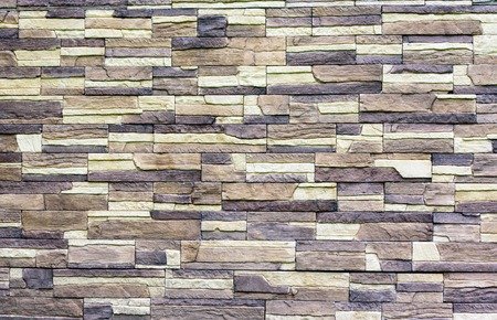 Wall of bricks of different shades of brown
