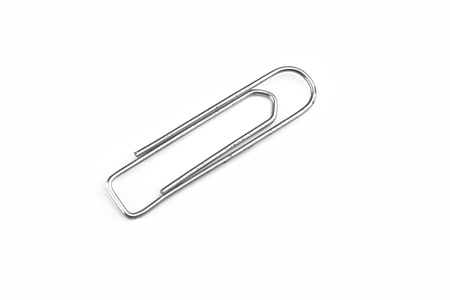 Old steel paper clip isolated on white background. Copy spaceの写真素材