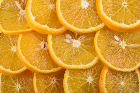 Background of ripe juicy orange slices. The texture of orange.